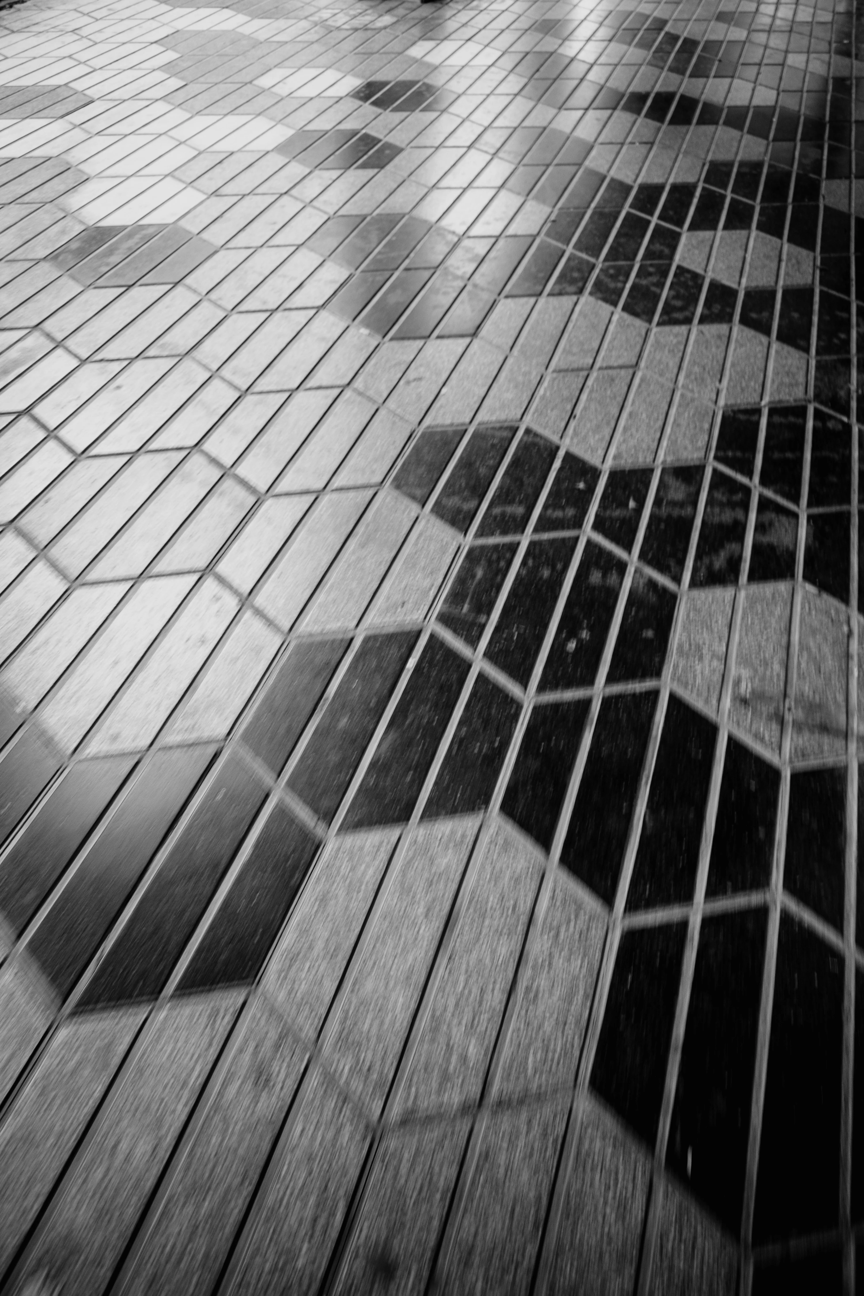 Black and white geometric floor tiles with hexagonal and diamond patterns.